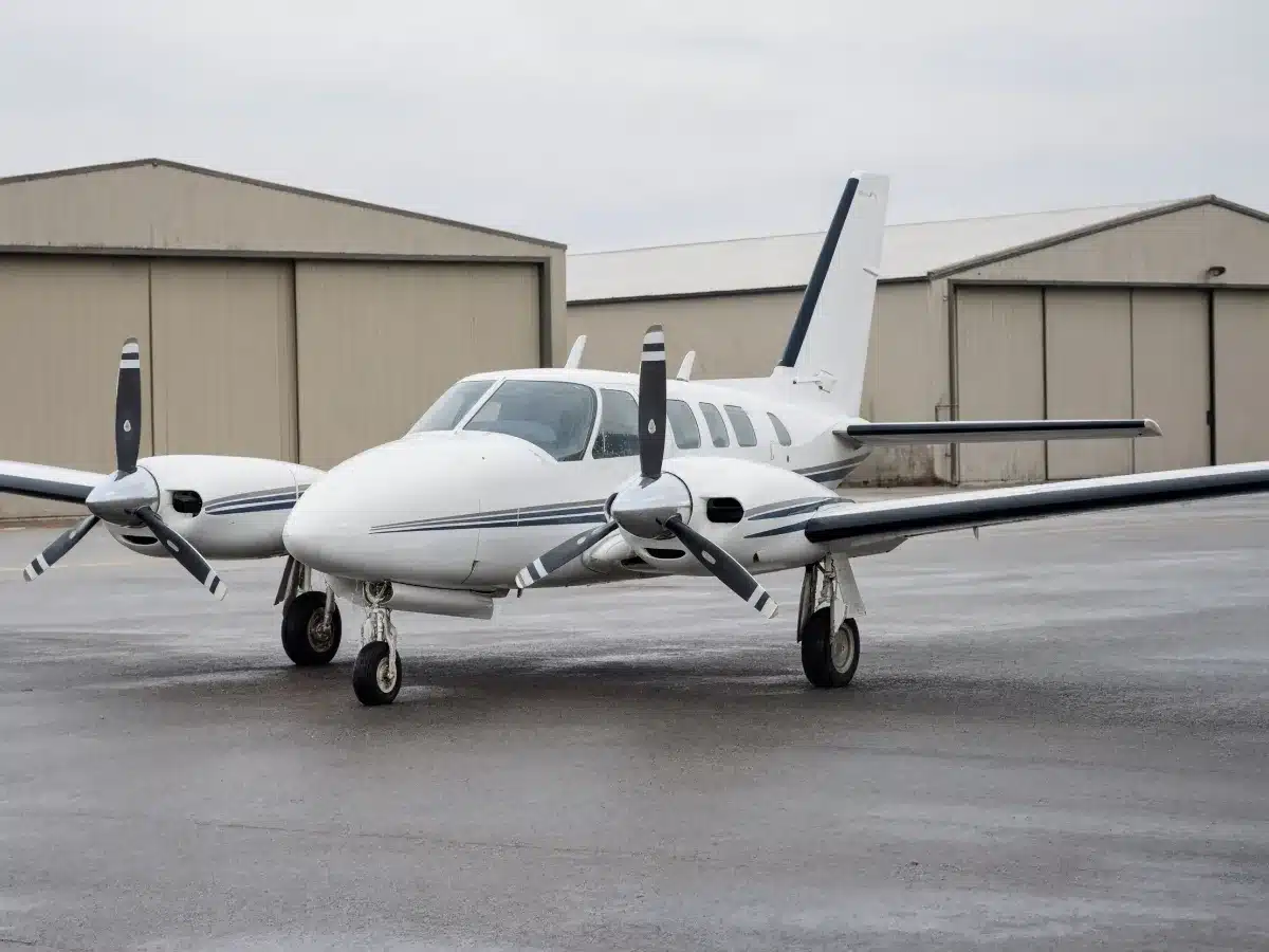 A twin-engine piston airplane on an airport ramp