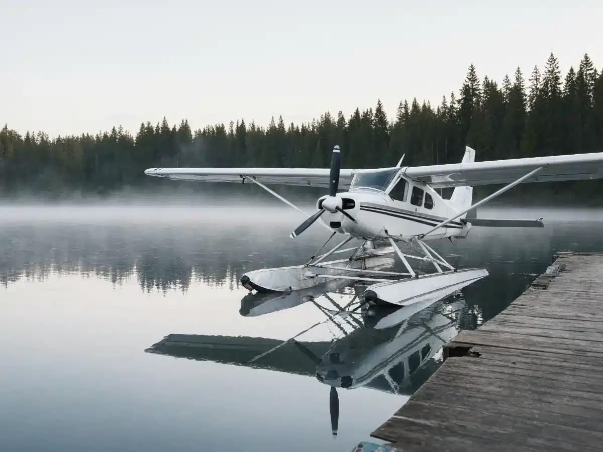 A floatplane on calm water near a dock